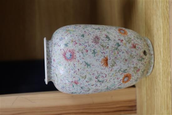 A Chinese famille rose ovoid vase, Qing dynasty, finely painted with flowers and scrolling foliage, H. 15cm, drilled hole to side of ba